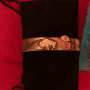 A close up of the wrist band on someone 's arm.